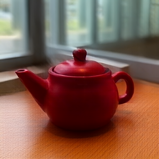 A red ceramic teapot on a wooden table beside a window